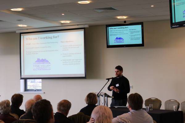 Matthew delivering his presentation to the conference audience